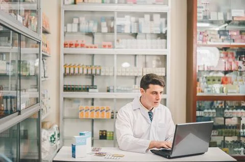 Male pharmacist checking, analyzing or Checks Inventory of Medicine, Drugs,.. Stock Photos