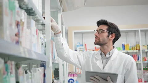 Male pharmacist using digital tablet and wear gloves reduce exposure Stock Footage 150135372