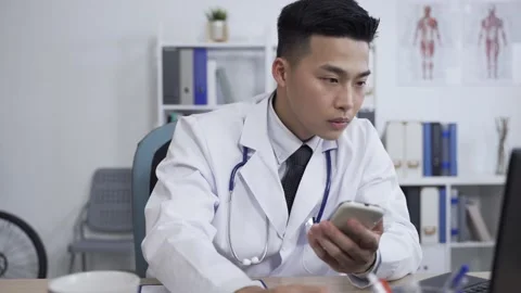 Male physician is looking at his computer Stock Footage 156609820
