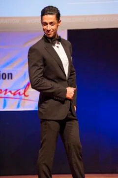 Male physique model shows his best in suit on stage Stock Photos