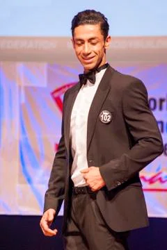 Male physique model shows his best in suit on stage Stock Photos