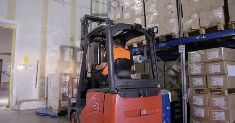 Male Picking Up Boxes With Forklift Stock Footage 142895110