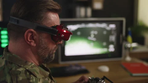 Male pilot practicing tactical FPV drone control in Ukrainian command center Stock Footage 333307996