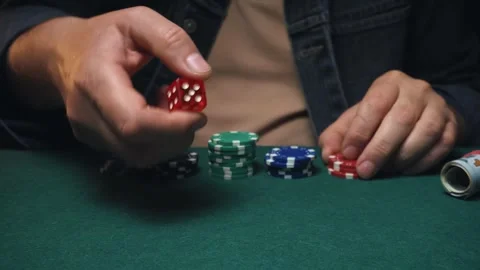 Male player craps with hands visible stacks colorful poker chips and rolls dice Stock Footage 337196920