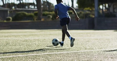 Male player is dribbling ball, causing teammate to receive and advance for shot Stock Footage 339558568