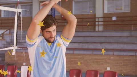 Male player starting hands back, swinging arms by volleyball net, gold stars Stock Footage 333894393