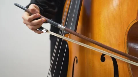 Male playing cello in musical performance. A musician playing classical music Stock Footage 259349205