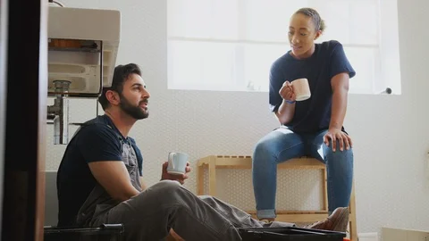 Male Plumber With Female Apprentice Taking A Break From Fixing Leaking Sink In Video stock 124569335