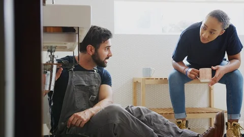 Male Plumber Teaching Female Apprentice To Fix Leaking Sink In Home Bathroom Video stock 124569376