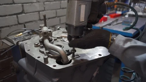 Male pneumatic mechanic disassembles engine Stock Footage 102867029