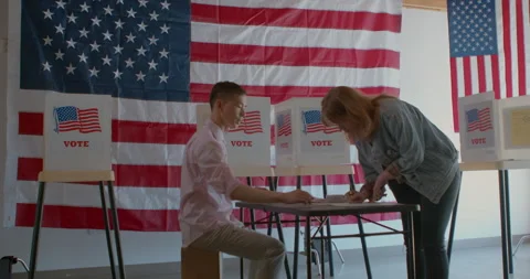 Male poll worker processing voters at a polling station Stock Footage 274982267