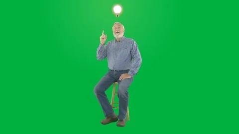 Male ponding on a problem then coming up with and idea that lights a light bulb Stock Footage 110764405