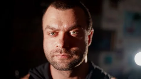 Male portrait with dramatic lighting. Half of the face is illuminated  Stock Footage 302171788