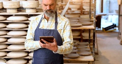 Male potter using digital tablet 4k Stock Footage 85318609