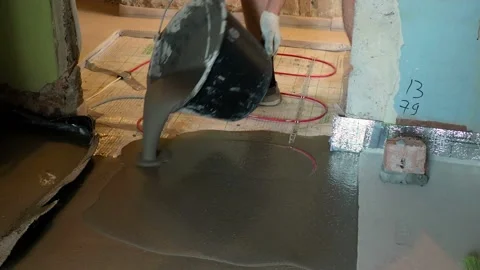 Male pouring concrete slab on heating cable Stock Footage 113685967