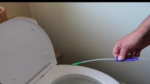 Male preparing to use an intermittent catheter in a home environment holdin.. Stock Footage 343417539