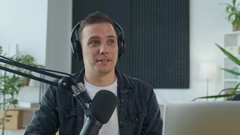 Male Presenter Creates Audio Content, Records a Podcast or Radio Show Stock Footage 163387097