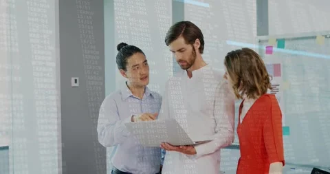 Male presenter opening laptop explaining data with team as code streams Stock Footage 320128495