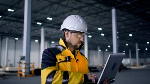 A male process engineer works on a personal computer. Portrait of a professional Stock Footage 127943816