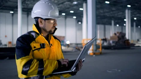 A male process engineer works on a personal computer. Portrait of a professional Видео 128616229