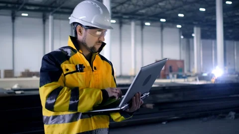 A male process engineer works on a personal computer. Portrait of a professional Stock Footage 128616254