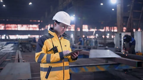 A male process engineer works on a personal computer. Portrait of a professional Stock Footage 240084948