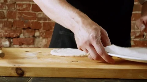 The male professional chef preparing a dough for making pizza. 4K Video stock 84945995