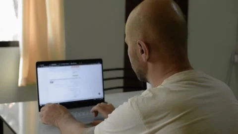 Male professional using computer sitting at home office desk. . Vídeo Stock 145465428