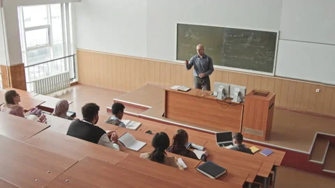 Male Professor Teaching Maths to Students in Lecture Hall Stock Footage 155463955