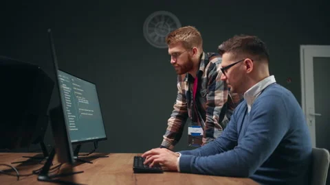 Male programmer and project manager discussing and making decisions in office Stock Footage 233739467