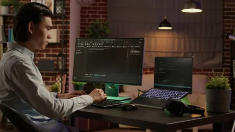 Male programmer coding encryption on security software Stock Footage 200372348