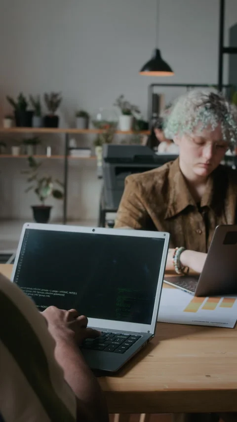 Male Programmer Coding on Laptop at Shared Desk in Office Video stock 306218826