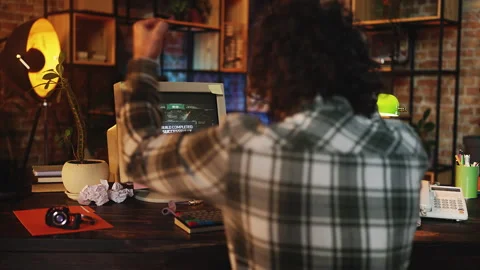 Male programmer completing successful computer project in retro office setting Stock Footage 315456974