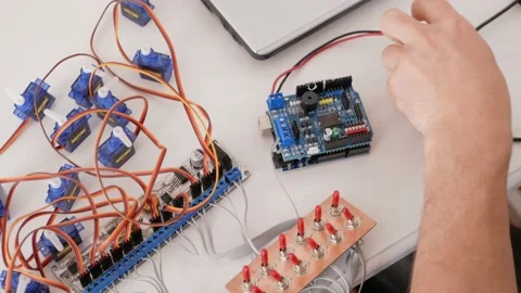 A male programmer creates robotics Stock Footage 163815646