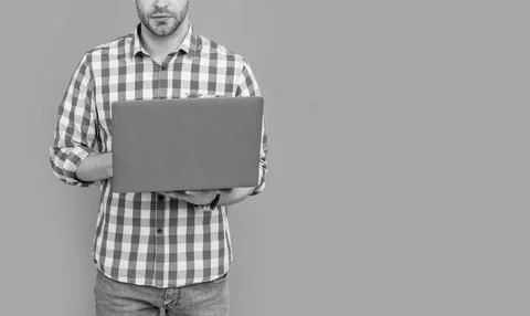 Male programmer crop view programming on laptop computer studio isolated on grey Stock Photos