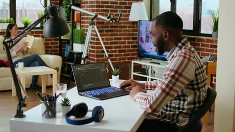 Male programmer developing an app on his laptop and working remotely Video stock 319717797