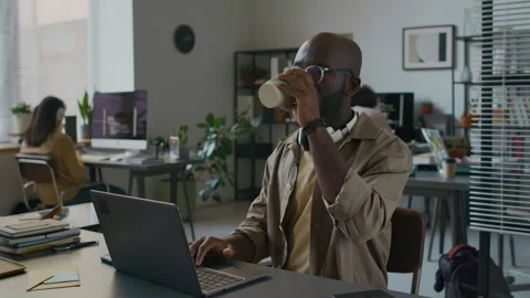 Male Programmer Drinking Coffee while Developing Application at Workplace Stock Footage 299239875