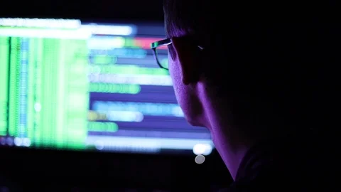 Male programmer with glasses working late at night Stock Footage 128381045