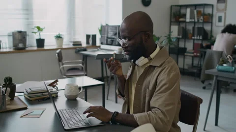 Male Programmer Having Phone Call with Customer while Working on Laptop Stock Footage 299241324