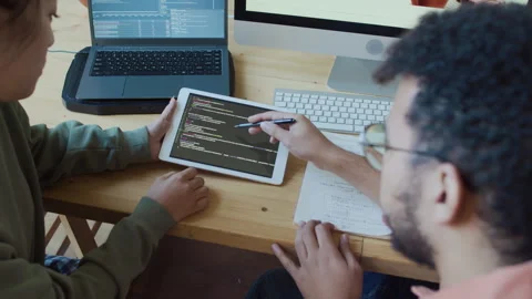 Male Programmer Helping Female Junior Colleague Fix Bugs in Code Stock Footage 293121597