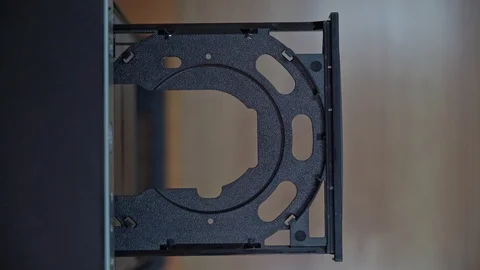 A male programmer inserts a CD-DVD from a computer drive. View from above Stock Footage 125698289