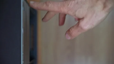 A male programmer inserts a CD-DVD from a computer drive. View from above Stock Footage 126125782