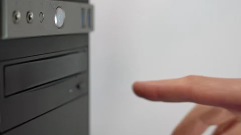 A male programmer inserts a CD-DVD from a computer drive. View from above Stock Footage 127788239