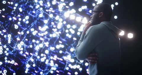 Male Programmer Looking at Data on Big Screen Stock Footage 243288433
