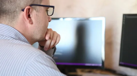 Male programmer looking for errors in the program code. Stock Footage 64830394