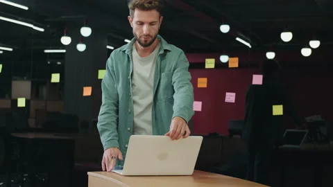 A male programmer opens a laptop and starts working. Stock Footage 209184901