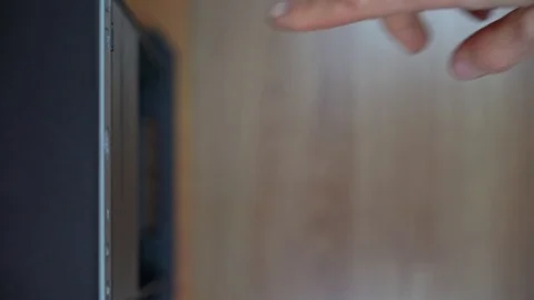 A male programmer takes out a CD-DVD from a computer drive. View from above Stock Footage 125644244