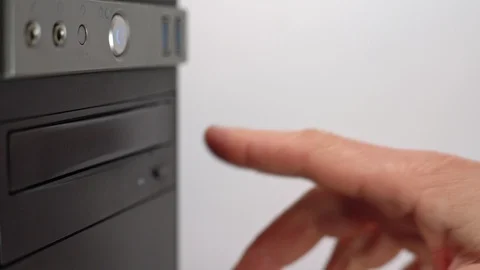 A male programmer takes out a CD-DVD from a computer drive. Side view. Outdated Stock Footage 125644321