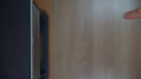 A male programmer takes out a CD-DVD from a computer drive. View from above Stock Footage 125679600