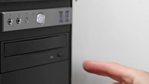 A male programmer takes out a CD-DVD from a computer drive. View from above Stock Footage 126169450